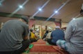 People listening to the Friday sermon at a mosque.