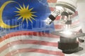 Microscope on Malaysia flag - science development digital background. Research of physics design concept, 3D illustration of