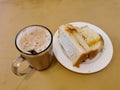 Malaysian breakfast which is milk tea or the tarik, half boiled eggs and kaya butter toast set on the table. Royalty Free Stock Photo