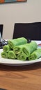 Malaysian delicacy called Kuih Ketayap. The green crepe filled with coconut.