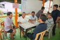 Malaysian men under a leantoo playing checkers Royalty Free Stock Photo