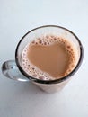 Malaysian signature drink called `TEH TARIK`. Tea drinks mixed with creamy white creamers.