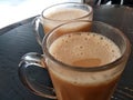 Malaysian signature drink called `TEH TARIK`. Tea drinks mixed with creamy white creamers.