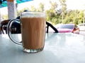 Malaysian signature drink called `TEH TARIK`. Tea drinks mixed with creamy white creamers.