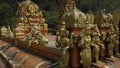 Malaysian temple with golden statues of the saints. Action. Concept of religion and culture. Royalty Free Stock Photo