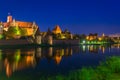 Malbork castle over the Nogat river at night, Poland