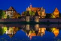 Malbork castle over the Nogat river at night, Poland