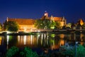 Malbork castle over the Nogat river at night, Poland