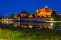 Malbork castle over the Nogat river at night, Poland