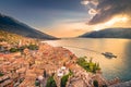 Malcesine roofs and fortress with boat at sunset, Garda Lake, Italy Royalty Free Stock Photo
