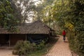 A narrow lane going past a thatched roof hut in the village of Pandua in Malda