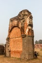 Ruins of a brick and stone wall at the ancient site of the Adina Masjid mosque in the