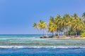 Beautiful beach with palm trees and moody sky. Summer vacation travel holiday background concept. Maldives paradise beach Royalty Free Stock Photo