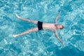 Maldives. The boy has a rest on transparent water