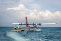 Maldives, Feb 10th 2018 - A seaplane waiting for tourists in a offshore wood platform near the Hilton Hotel in Maldives. Blue wate