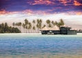 Maldives. houses on piles on water at the time sunset Royalty Free Stock Photo