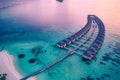 Maldives island sunset. Water bungalows resort at islands beach. Indian Ocean, Maldives Royalty Free Stock Photo