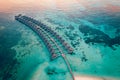 Maldives island sunset. Water bungalows resort at islands beach. Indian Ocean, Maldives Royalty Free Stock Photo