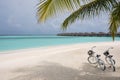 Tropical paradise resort with two bikes during a sunny day.