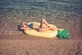 Maldives or Miami beach water. Girl sunbathing on beach with air mattress. Summer vacation and travel to ocean. Royalty Free Stock Photo