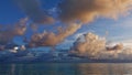 In the Maldives, sunset begins. Fantastic clouds of white, blue, golden, pink colors.