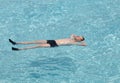 Maldives. Teenager has a rest on turquoise transparent water of ocean