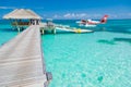 Ari Atoll, Maldives - 05.05.2018: Maldives seaplane on luxury resort, wooden jetty loading the plane, ready for departure.