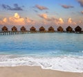 Maldives. Villa on piles on water at the time sunset Royalty Free Stock Photo