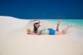 Maldives, woman Christmas hat, blue shorts and blouse, drinking Royalty Free Stock Photo