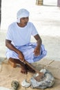 Maldivian construction worker in traditional national maldivian clothes sitting with axe near pile of rocks Royalty Free Stock Photo