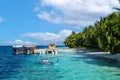 Maldivian dhoni and sailing boats at jetty landing stage of little harbor in turqouise blue indian ocean paradise island