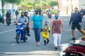 Maldivian family wearing masks walking on the street during covid-19