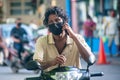 Maldivian man fixing mask on the bike during covid -19 corona virus pandemic