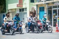 Maldivian men in the masks riding bikes at the street during corona virus pandemic