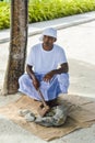 Maldivian muslim construction worker in traditional national maldivian clothes cracking coral rocks with the axe Royalty Free Stock Photo