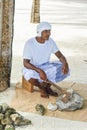 Maldivian muslim construction worker in traditional national maldivian clothes sitting near the coral rocks