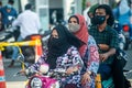 Maldivian people driving bilkes wearing masks during covid-19