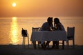 Maldivian silhouette. A young couple gazing into each others eyes while having dinner on the beach. Royalty Free Stock Photo