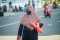 Maldivian woman wearing mask on the way to beach during covid-19