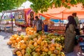 Maldivian women buying coconuts at market place at docks area