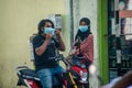 Maldivian young couple in masks at the street during covid -19 corona virus pandemic