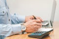 Male accountant making calculations,reviewing data in financial charts and graphs  at work place. Royalty Free Stock Photo