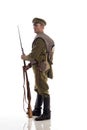 Male actor in the form of an ordinary soldier of the Russian army during the First World War posing against a white background in