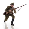 Male actor in the form of an ordinary soldier of the Russian army during the First World War posing against a white background in Royalty Free Stock Photo