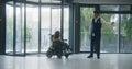 Male administrator meets woman in wheelchair in clinic Royalty Free Stock Photo