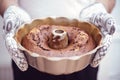 Male adult person holding out of the oven homemade bundt cake Royalty Free Stock Photo