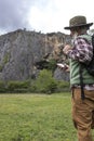 Male Adventurer Backpacker Using Smart phone On Top Of A Valley Royalty Free Stock Photo