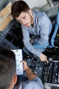 male aero engineer with clipboard working in cockpit Royalty Free Stock Photo