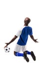 Male african american soccer player kneeling while celebrating goal on white background Royalty Free Stock Photo
