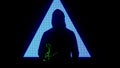 Male against big digital wall. Man in hoodie silhouette in front of digital screen wall with strobing neon symbols in